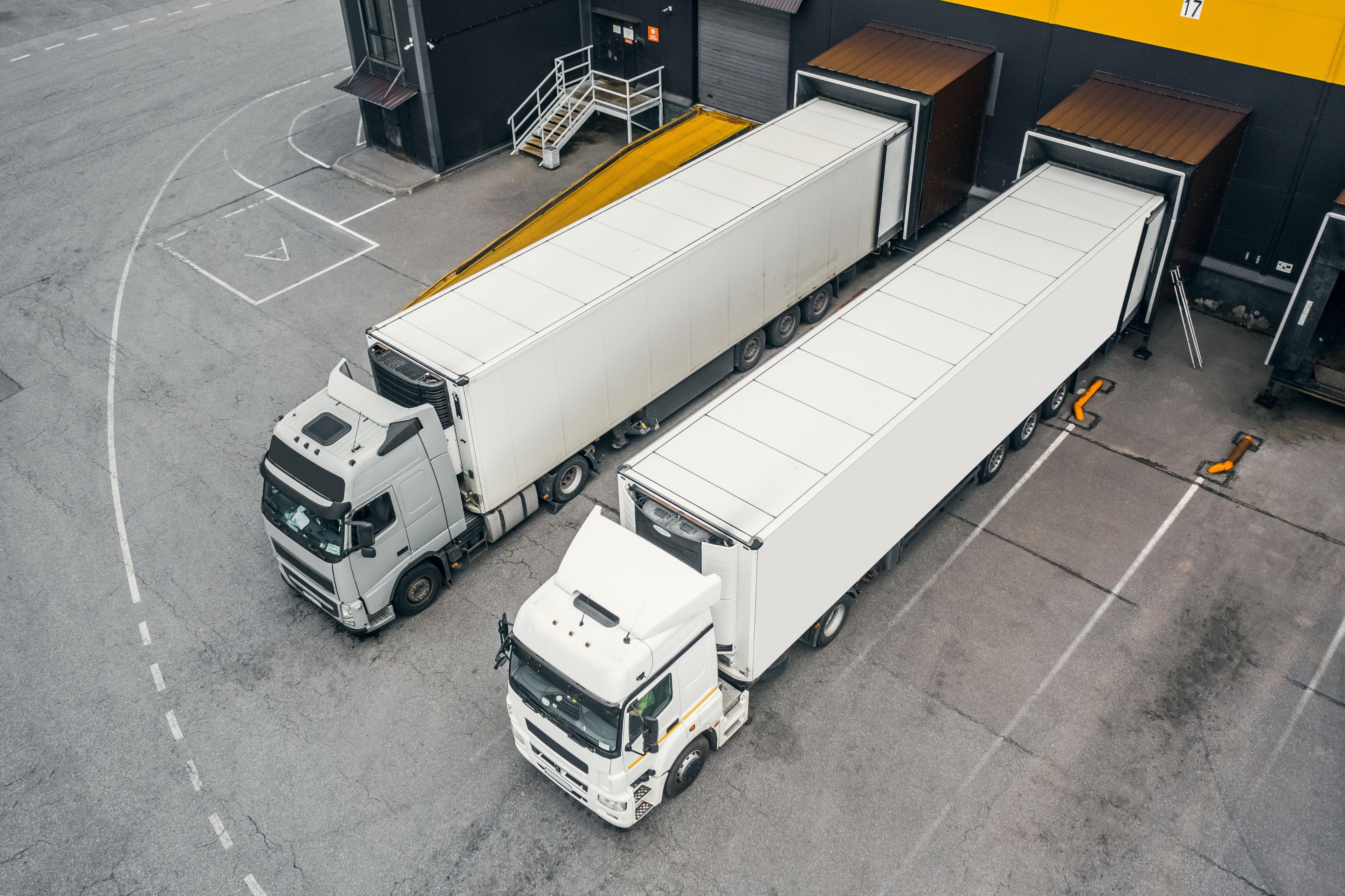Aerial view of two HGVs parked at a warehouse
